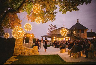 Hill country wedding reception with lights on the trees