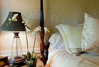 Side of the bed with night stand from one of the suites