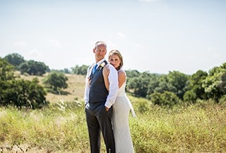 Newlyweds posing in middle of the hill country