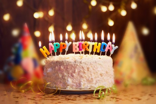 birthday cake and party decorations in the background